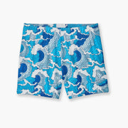 Blue and white waves printed on lounge short placed flat on grey background.