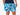 Close up front view of man wearing blue and white wave printed lounge shorts with hand in pocket.