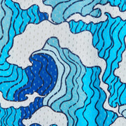 Close up detail shot of mesh material with blue and white waves printed on.