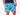 Close up front view of man wearing blue and white wave printed lounge shorts with hand in pocket.