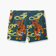 Green lounge shorts with tiger and snake print laid flat on gray background.