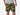 Front view of man wearing green lounge shorts with tiger and snake print with his hand in his pocket.